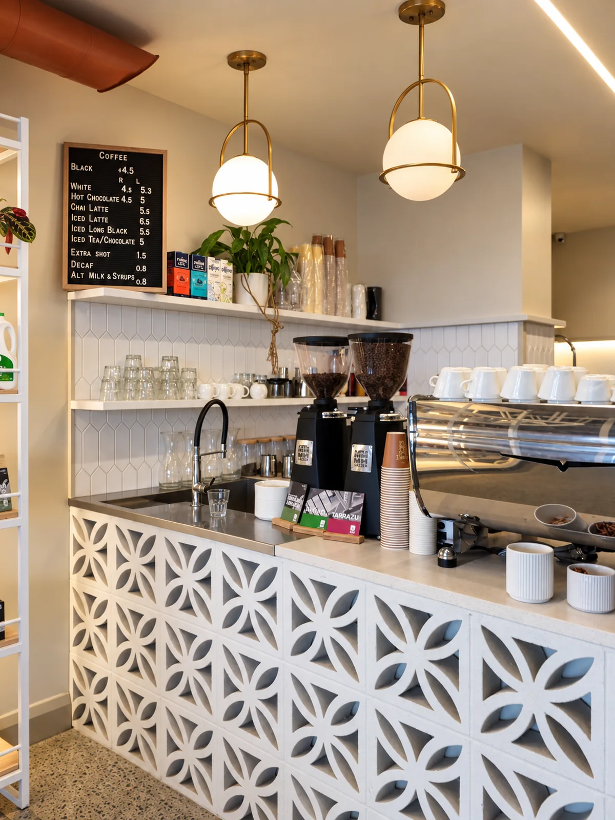 The Three One One Six coffee counter with hanging lights, espresso grinders and cups