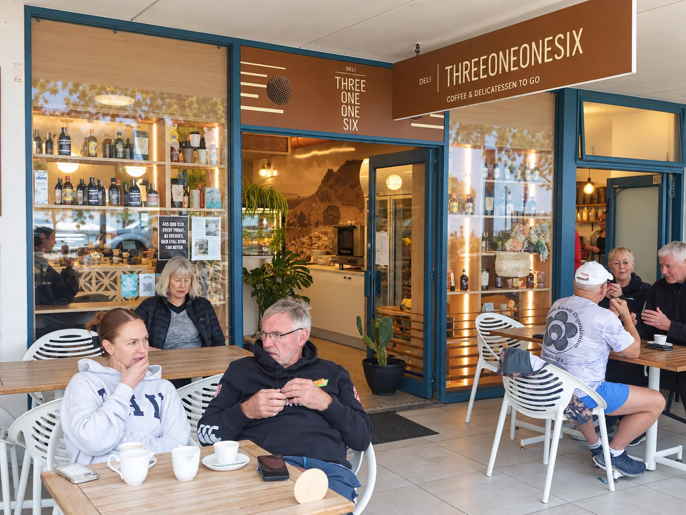 Customers seated outside the Three One One Six storefront